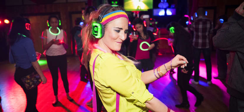 girl dancing with headphones at a silent disco