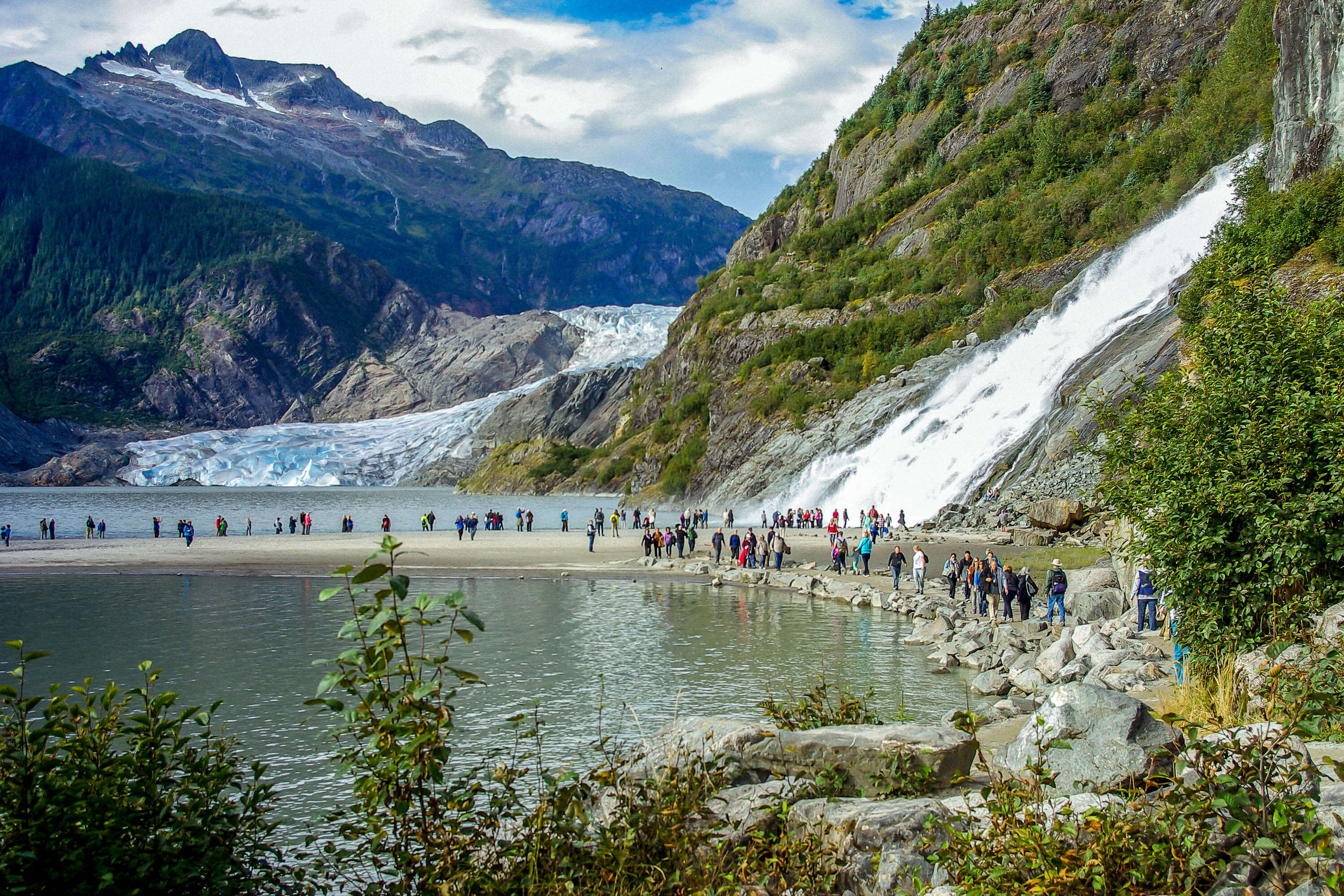 People gathered around Nugget Falls in Mendenhall Glacier