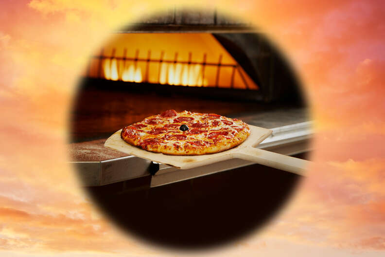 Bertucci's pepperoni pizza entering brick oven
