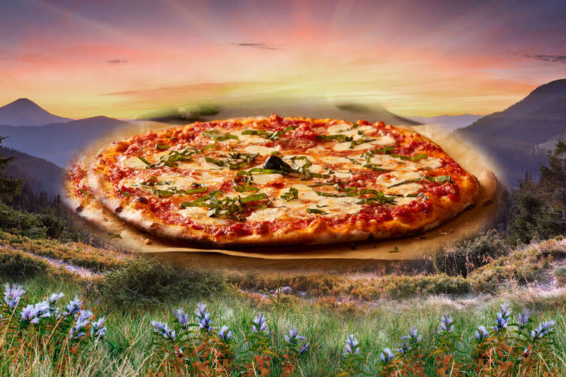 Pizza in front of sunset and meadow