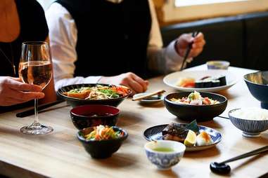 table with diners and sushi