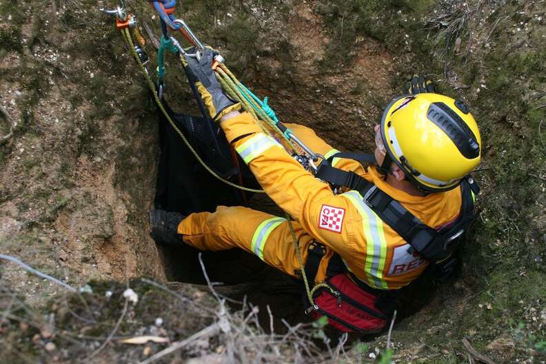 Rescuers saving wallaby down mineshaft