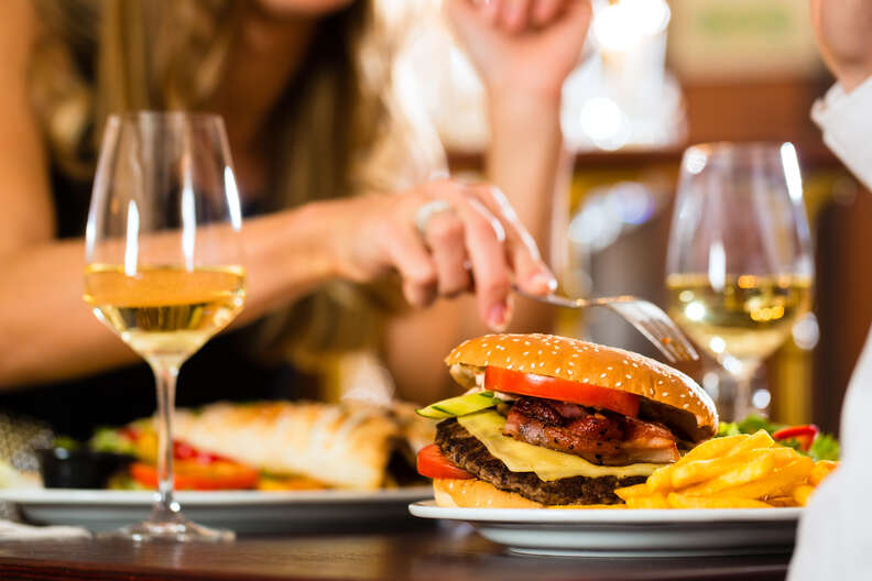 white wine glasses and hamburger on table