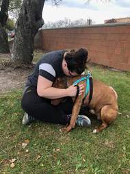 Woman sitting with dog outside