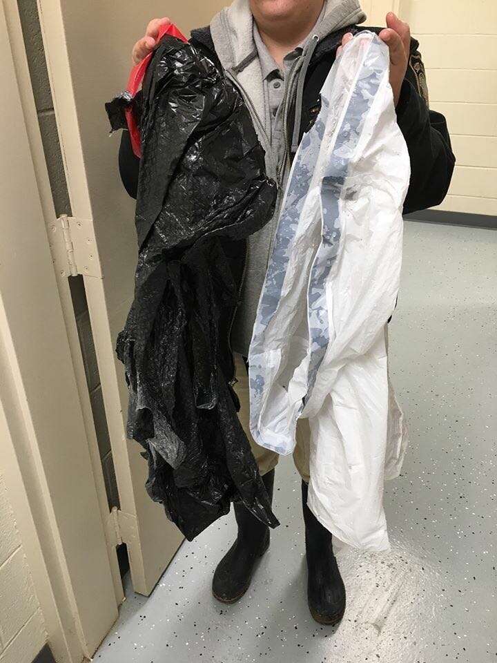 Person holding up two empty garbage bags