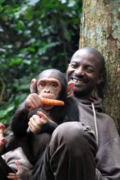 Smiling caregiver with rescued chimp