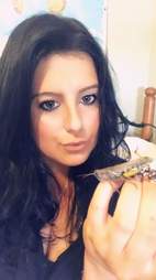 Woman holding grasshopper on her hand