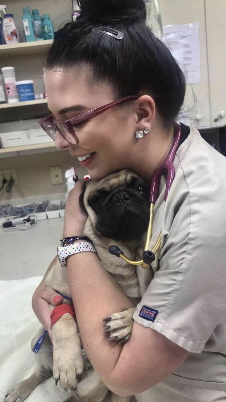 Vet tech Kayleen Campbell holds a sick pug