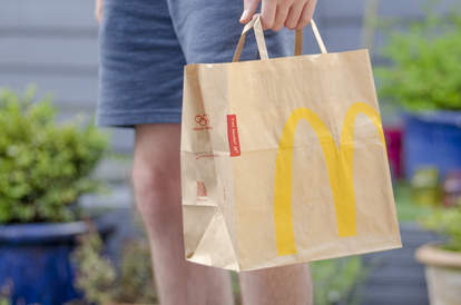 mcdonald's bag held by man