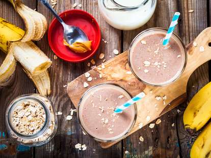 banana smoothie with oatmeal, peanut butter and milk with straw