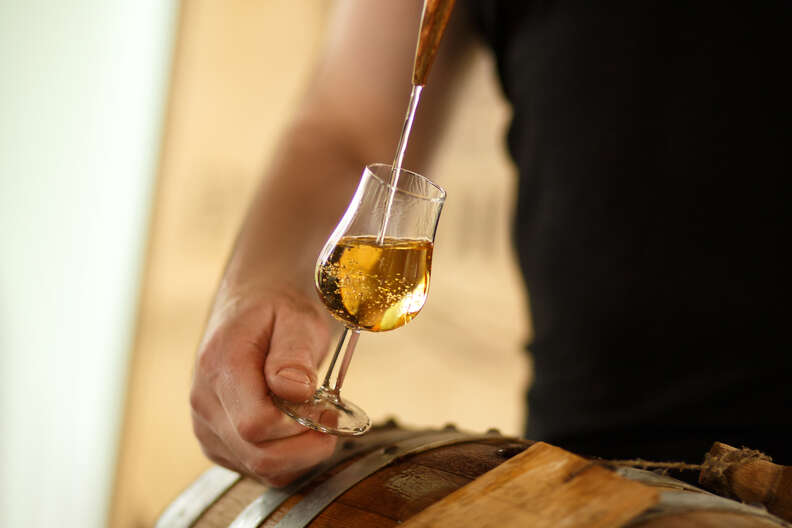 whiskey poured over barrel