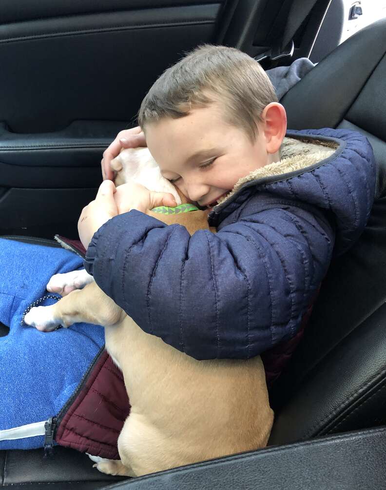 6-year-old Leo snuggles his new adopted puppy