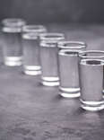 pouring vodka into glass vodkas liquor hard alcohol shot glasses shots buying guide thrillist