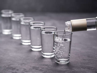 pouring vodka into glass vodkas liquor hard alcohol shot glasses shots buying guide thrillist