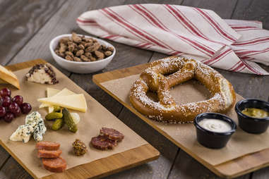 charcuterie, nuts, and a large pretzel