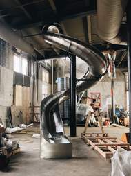 When it’s completed, J. Rieger & Co.’s state-of-the-art distillery will feature a 40-foot-slide that guests can use to get from the bar to the exit.