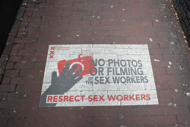 Close-up of spray painted sign on the floor of the Red Light District