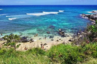 people wandering along crystalline water on the North Shore of Maui