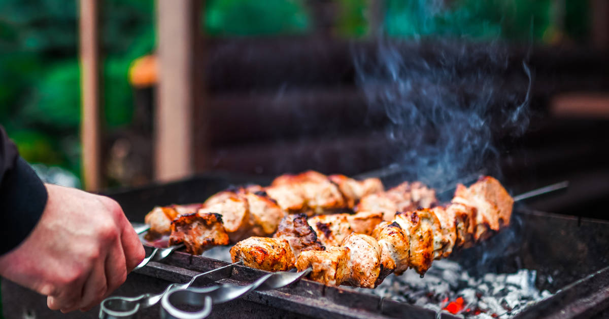 Grilling Marinated Shashlik On A Grill. Shashlik Is A Form Of Shish Kebab  Popular In Eastern, Central Europe And Other Places. Shashlyk (meaning  Skewered Meat) Was Originally Made Of Lamb. Stock Photo