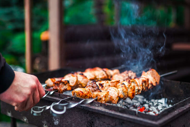 Grilled kebab cooking on metal skewer