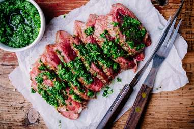 grilled barbecue beef steak with green chimichurri sauce