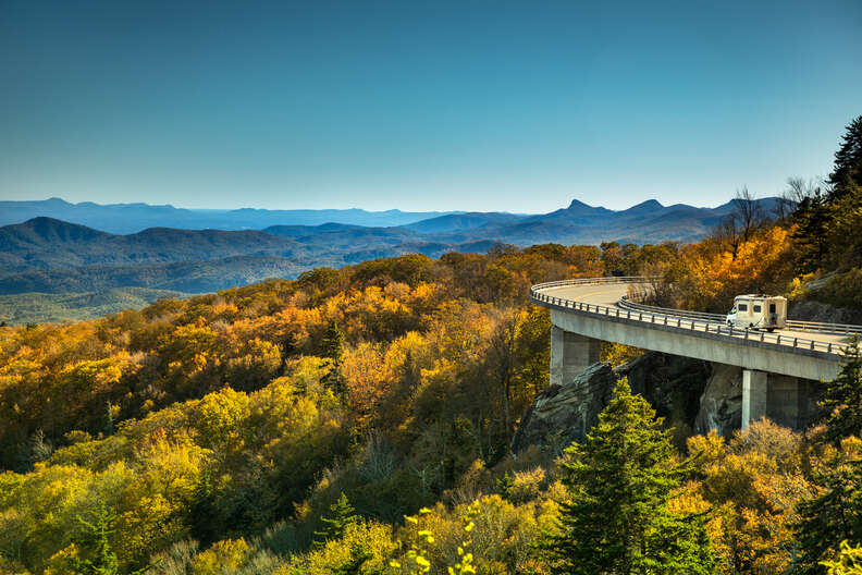 an rv rolling along a road through the blue ridge parkway