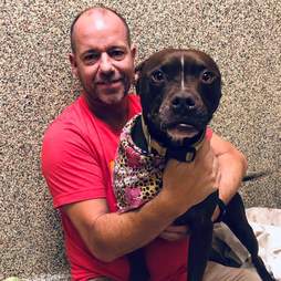 Man hugging shelter dog
