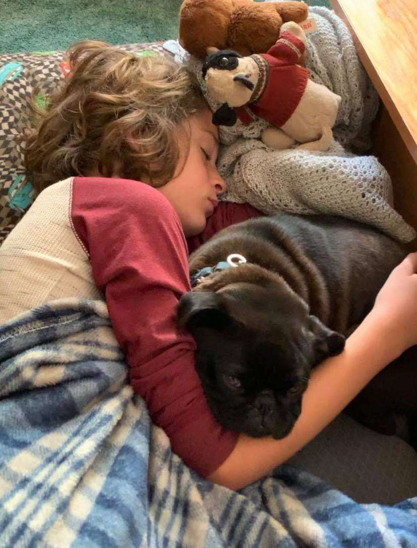 Carter Licata snuggles his dog Piper