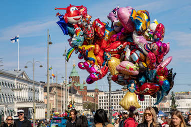 a collection of balloons over a crowd in finland