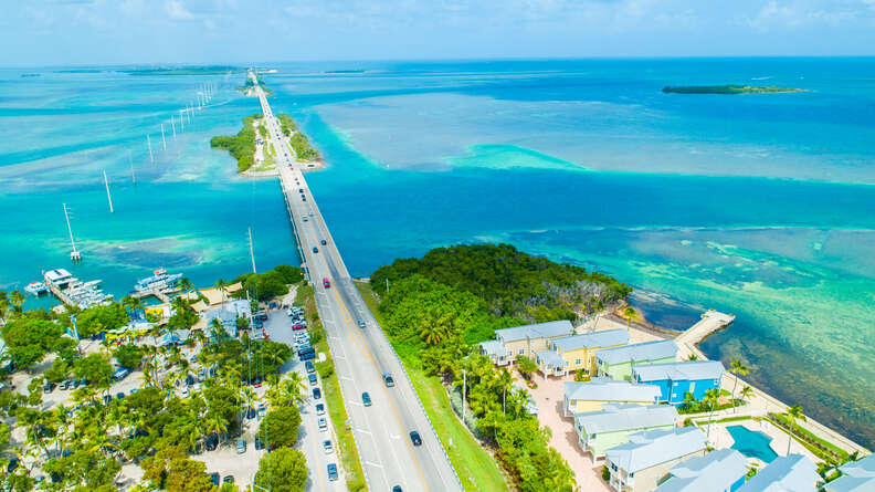 a long bridge headed out into the ocean