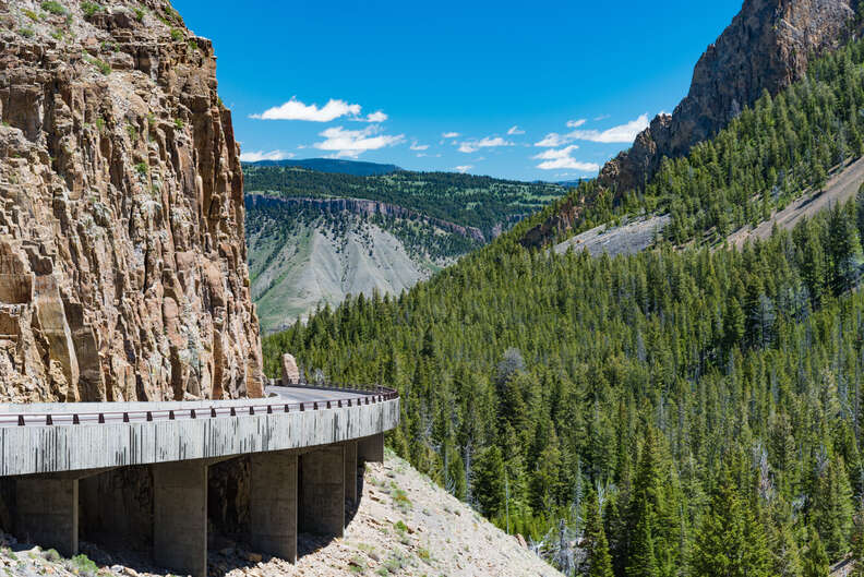 a road leading around a forested mountain