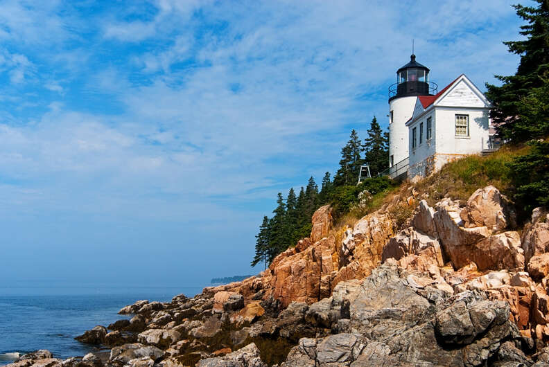 lighthouse on a rocky cliff overlooking the ocean