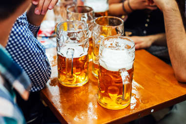 friends drinking tall beers in Munich, Germany