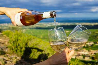 a person pouring two glasses of wine in Solutré-Pouilly, France