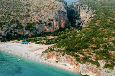 aerial view of gjipe beach surrounded by mountainous terrain 