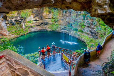 people looking down at an underground swimming pool