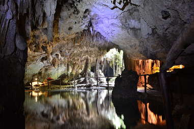 a dark water natural pool in an underground cave