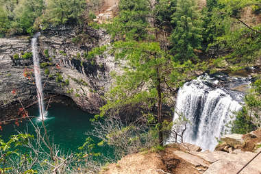 several waterfalls streaming into a lake