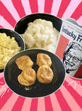 KFC mac and cheese, mashed potatoes, bucket of chicken, and biscuits