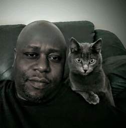 Animal rescuer Calvin Tucker poses with his cat Henry