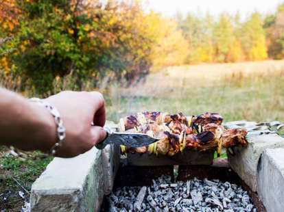 fish cooking over campfire