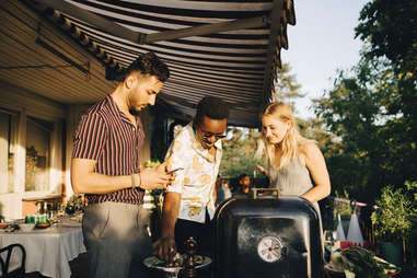 friends grilling together outdoors bbq