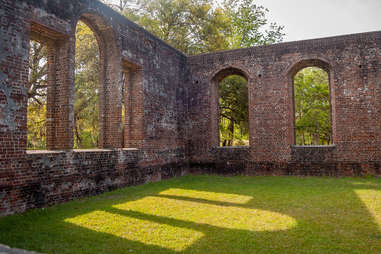 the structure and windows of an abandoned fort in a field