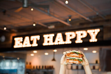 Mendocino Farms sandwich in front of “Eat Happy” sign