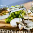 pouring white wine into glass