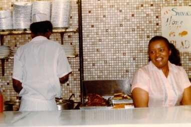 Sylvia Woods “The Queen of Soul Food” behind the luncheonette counter