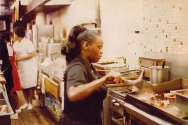 Sylvia Woods “The Queen of Soul Food” behind the luncheonette counter