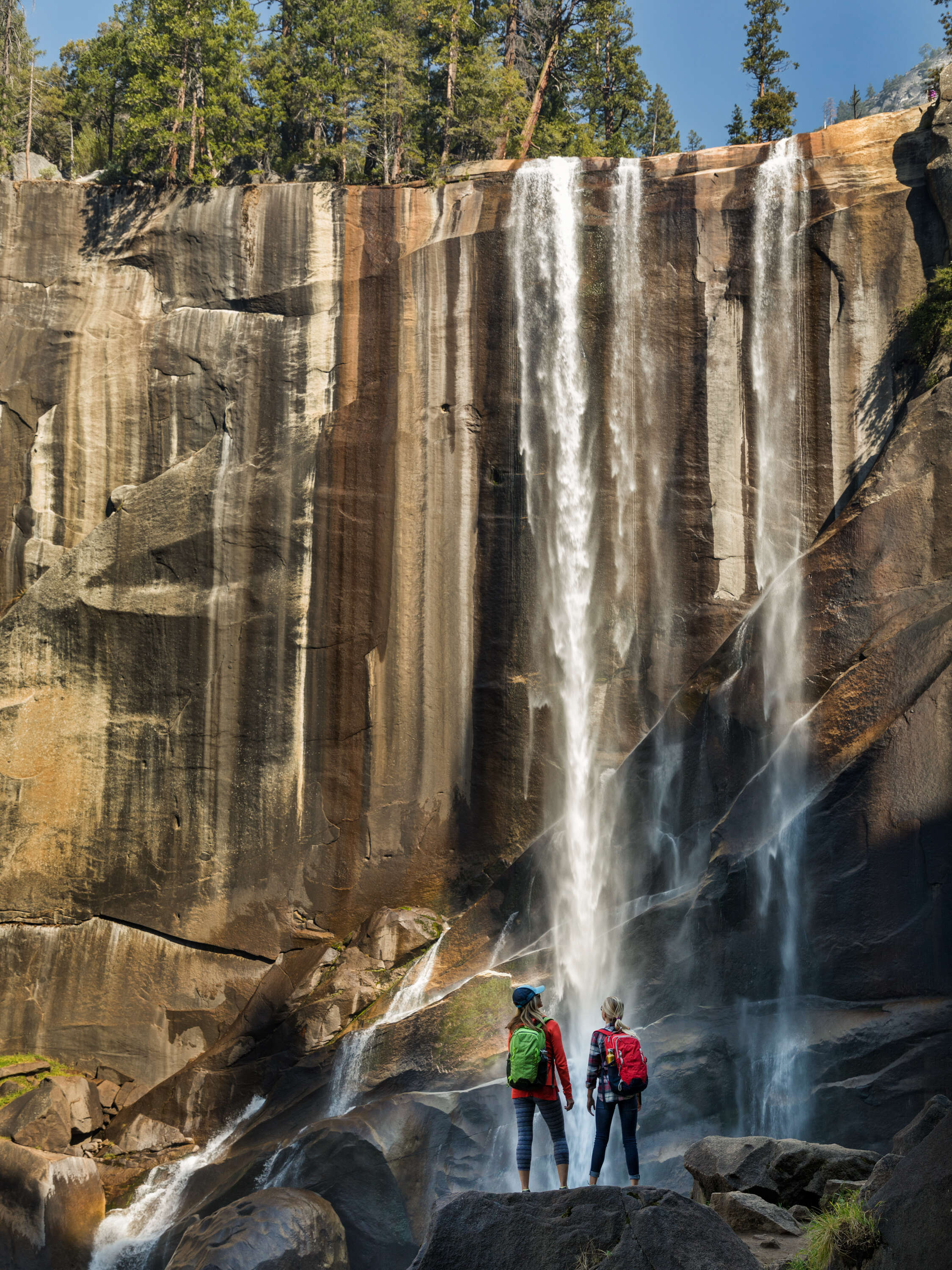 spring hikers standing in front of a waterfall