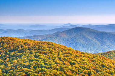 a mountain range covered in colorful fall trees