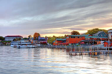 docked buildings and a hotel surrounding a lake at sunset